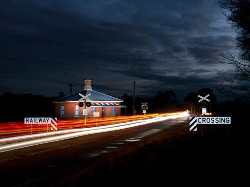 Cars crossing a railway crossing at night