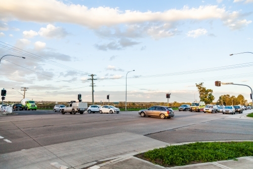 Cars crossing intersection with traffic lights - Australian Stock Image