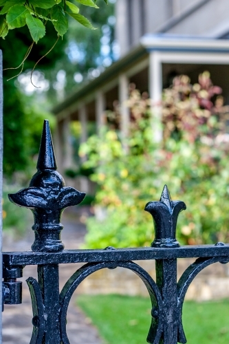 Cast iron fence outside historic house and garden - Australian Stock Image