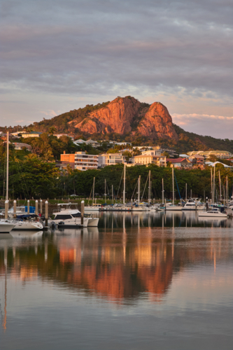 Castle Hill reflected in water with boats in marina - Australian Stock Image