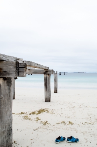 Castletown Jetty ruins on the beach and forgotten shoes - Australian Stock Image