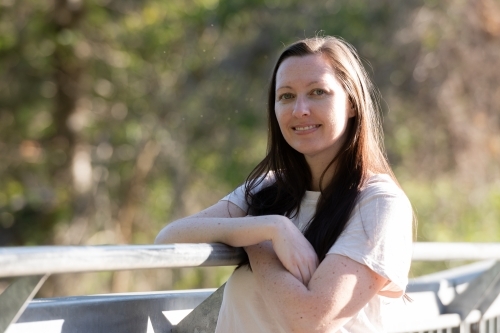 Casual, environmental portrait of a  young woman with blurred background - Australian Stock Image