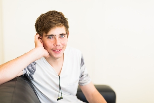 Casual relaxed smiling teenage boy - Australian Stock Image