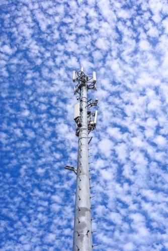 Cell phone telecommunication tower against blue sky and amazing clouds background, Melbourne - Australian Stock Image