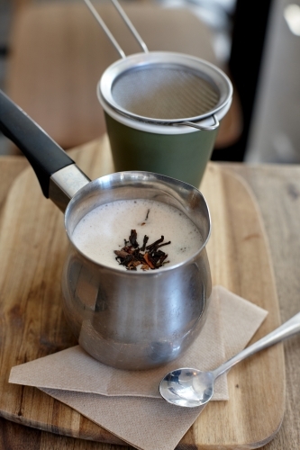 Chai latte prepared on table in cafe - Australian Stock Image