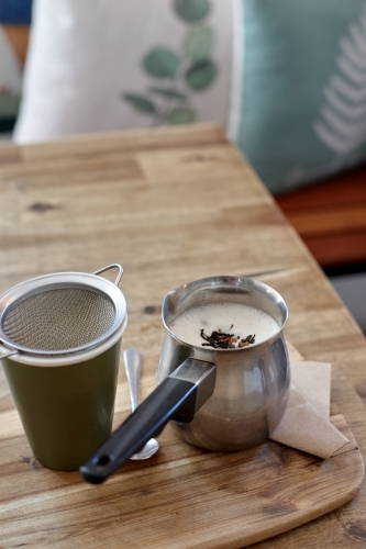 Chai latte prepared on table in cafe - Australian Stock Image