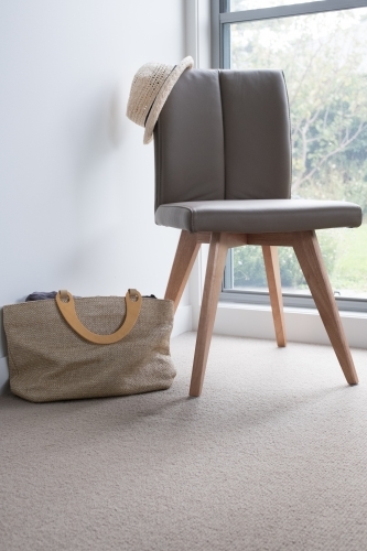 Chair with hat and bag as part of bedroom interior design - Australian Stock Image
