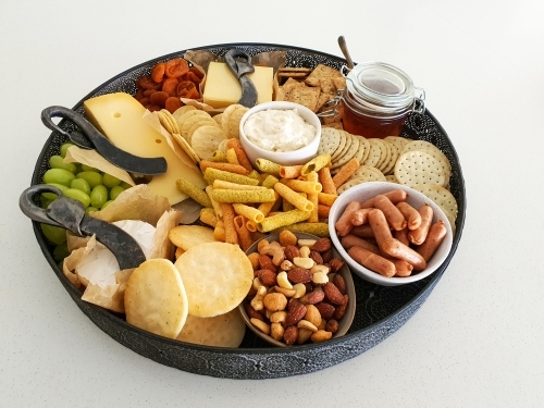 cheese platter on white bench