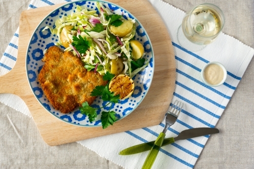 Chicken schnitzel and salad dish - Australian Stock Image