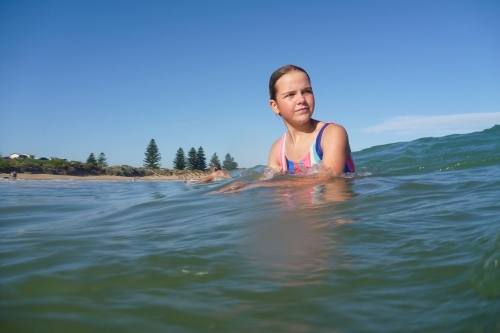 Child catching wave - Australian Stock Image