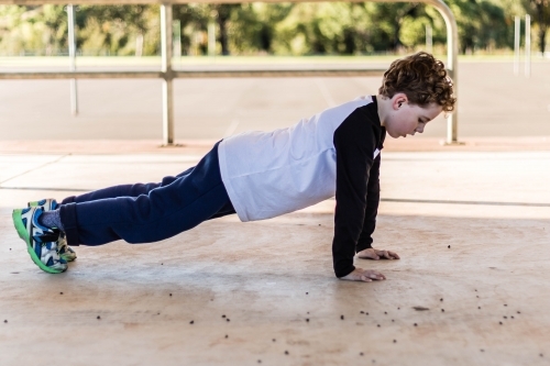 Child doing push up - Australian Stock Image