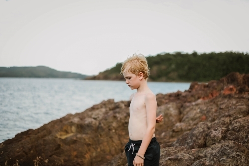 Child exploring Coral Beach in the Whitsundays - Australian Stock Image