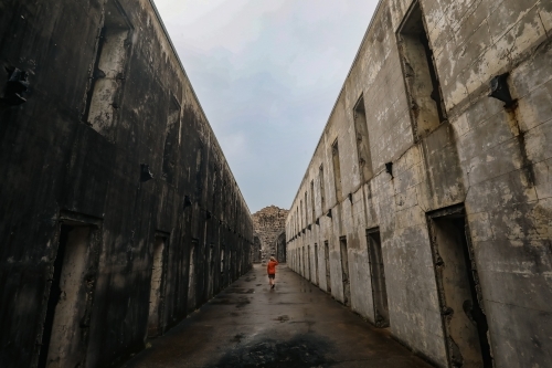 Child exploring the ruins of Trial Bay Gaol at Arakoon NSW Australia - Australian Stock Image