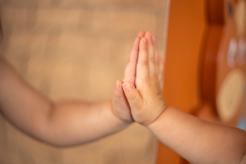 Child's hand reflection in the mirror - Australian Stock Image