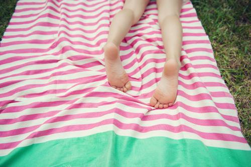 Child Sunbaking on a Turkish Towel - Australian Stock Image
