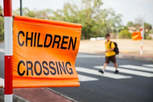 Children crossing sign at zebra crossing beside Aussie Public school - Australian Stock Image