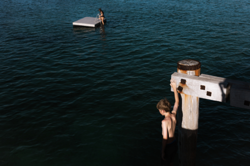 Children on pontoon and jetty in late summer sun - Australian Stock Image