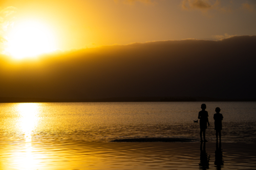 Children playing at sunset - Australian Stock Image