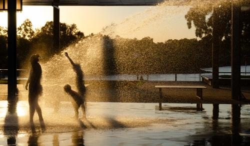 Children playing in a playground water jets at Eastshores recreation area, in Gladstone, Queensland - Australian Stock Image