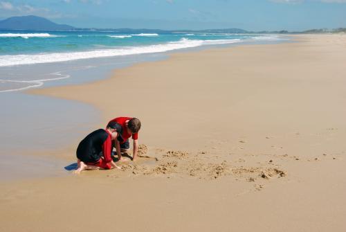 Children playing in the sand at the Beach - Australian Stock Image