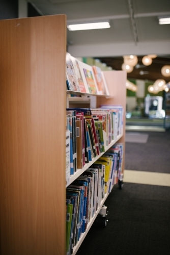 Children's books on a library shelf - Australian Stock Image