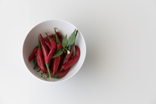 Chillis In A White Bowl - Left - Australian Stock Image