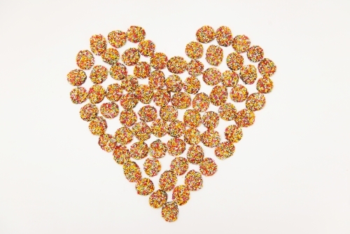 Chocolate freckles in the shape of a heart - Australian Stock Image