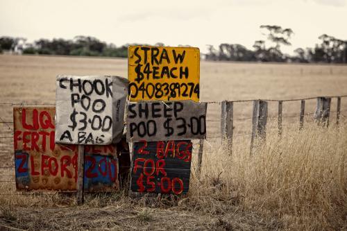 Chook and sheep poo for sale signs beside country road