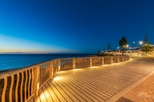 Christies Beach esplanade with Witton Bluff trail illuminated at night time - Australian Stock Image