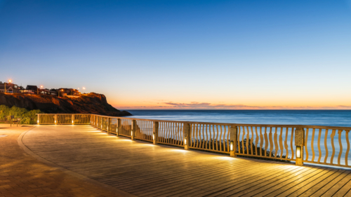 Christies Beach esplanade with Witton Bluff trail illuminated at night time - Australian Stock Image