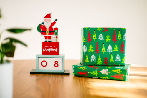 Christmas countdown decoration and gifts sitting on top of a wooden table - Australian Stock Image