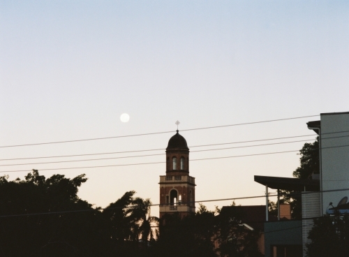 Church Steeple and city Silhouette under a Full Moon At Dusk - Australian Stock Image