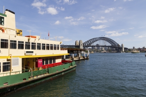 Circular Quay Sydney Harbour with NSW Transport Ferry and The Sydney Harbour Bridge in background - Australian Stock Image