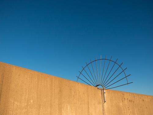 Circular spiked barrier to stop access to dam wall - Australian Stock Image
