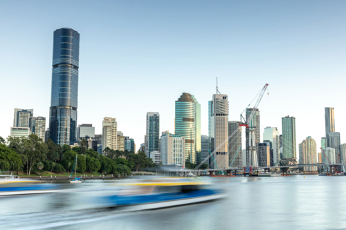 City-Cat boat speeding on river with city skyline - Australian Stock Image