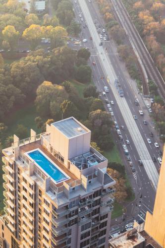 city living, view of an apartment building looking down onto the rooftop pool
