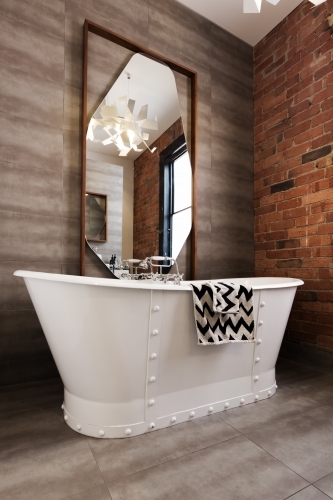 Classic white freestanding iron look bathtub in vintage style renovated bathroom