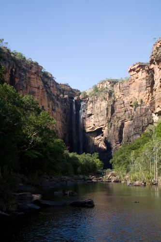 Cliff face with waterfall into creek - Australian Stock Image