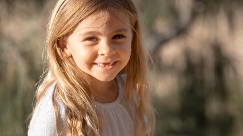 Close of up young girl with front teeth missing - Australian Stock Image