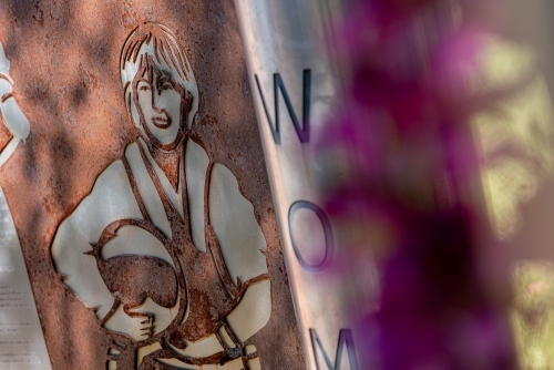 Close shot of a  metal signage of a person carrying a helmet - Australian Stock Image