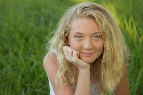 Close up of a blonde teen smiling outside - Australian Stock Image