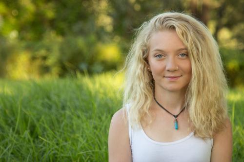 Close up of a blonde teen smiling outside - Australian Stock Image