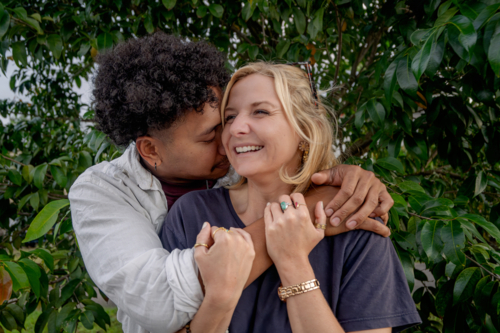 Close up of a man hugging his girlfriend, young happy and in love couple - Australian Stock Image