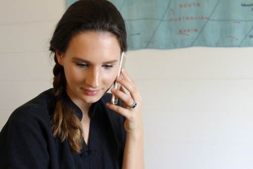 Close up of a young female talking on her mobile phone - Australian Stock Image