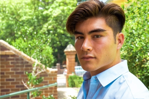 Close up of a young male outdoors wearing a business shirt - Australian Stock Image