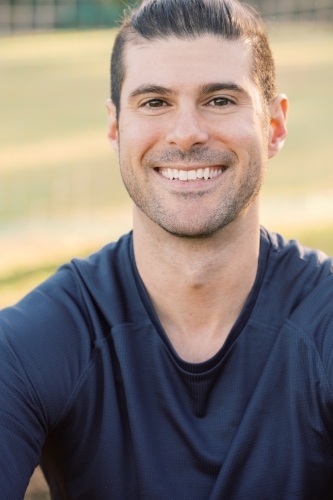 Close-up of a young sportsman at a soccer field wearing a blue shirt - Australian Stock Image