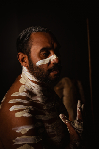 Close-up of aboriginal man with white body paint - Australian Stock Image