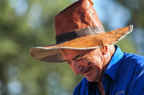 Close-up of an old farmer with home made leather hat.