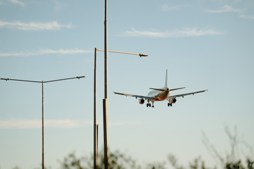 Close up of commercial airplane flying in the sky at daytime - Australian Stock Image