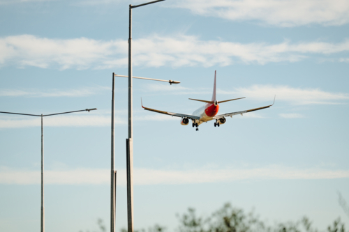 Close up of commercial airplane flying in the sky at daytime - Australian Stock Image